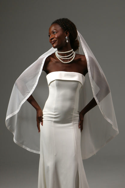 Romantic bridal accessory with soft dotted tulle and lace detail.