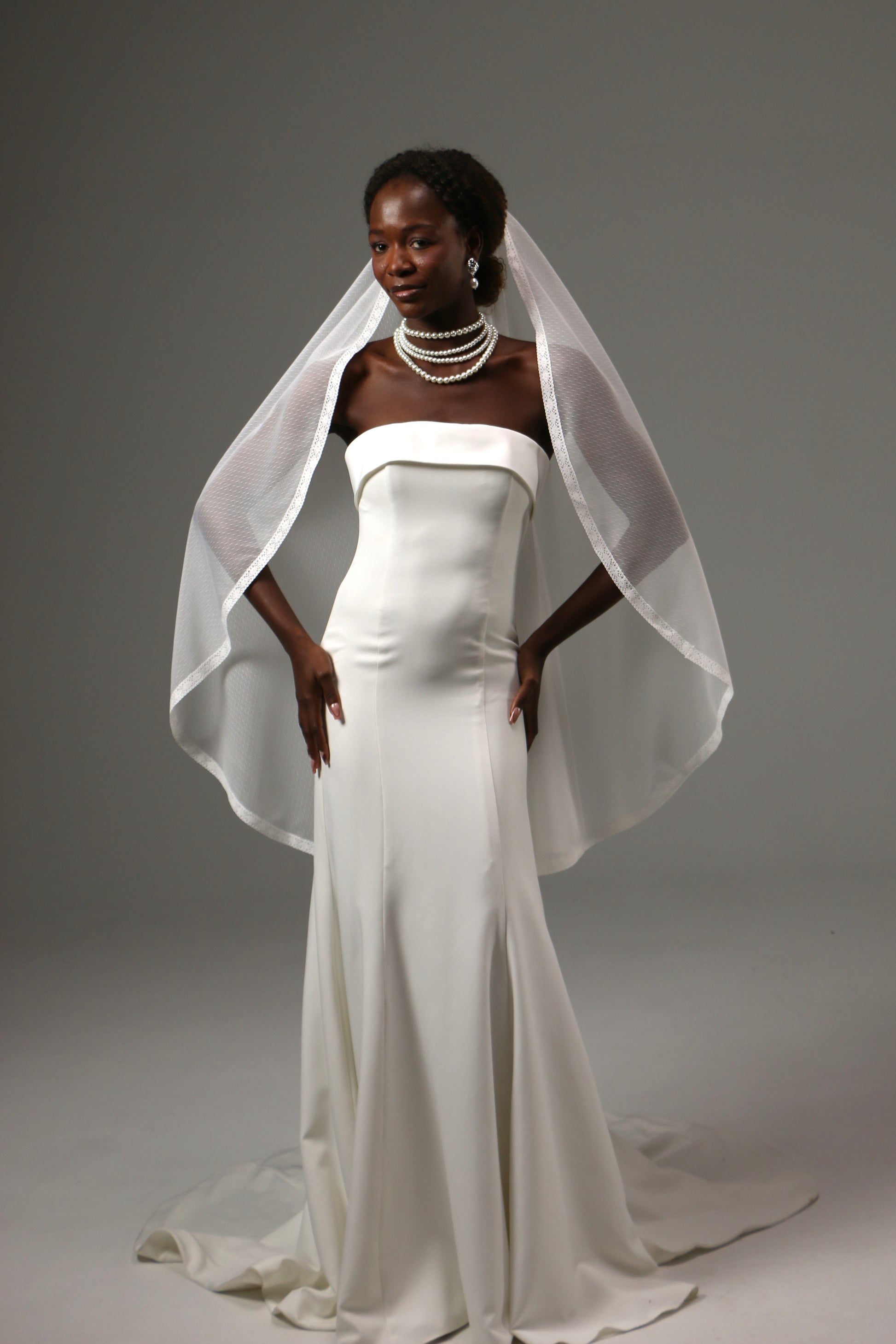 One-tier wedding veil styled with a minimalist satin gown.
