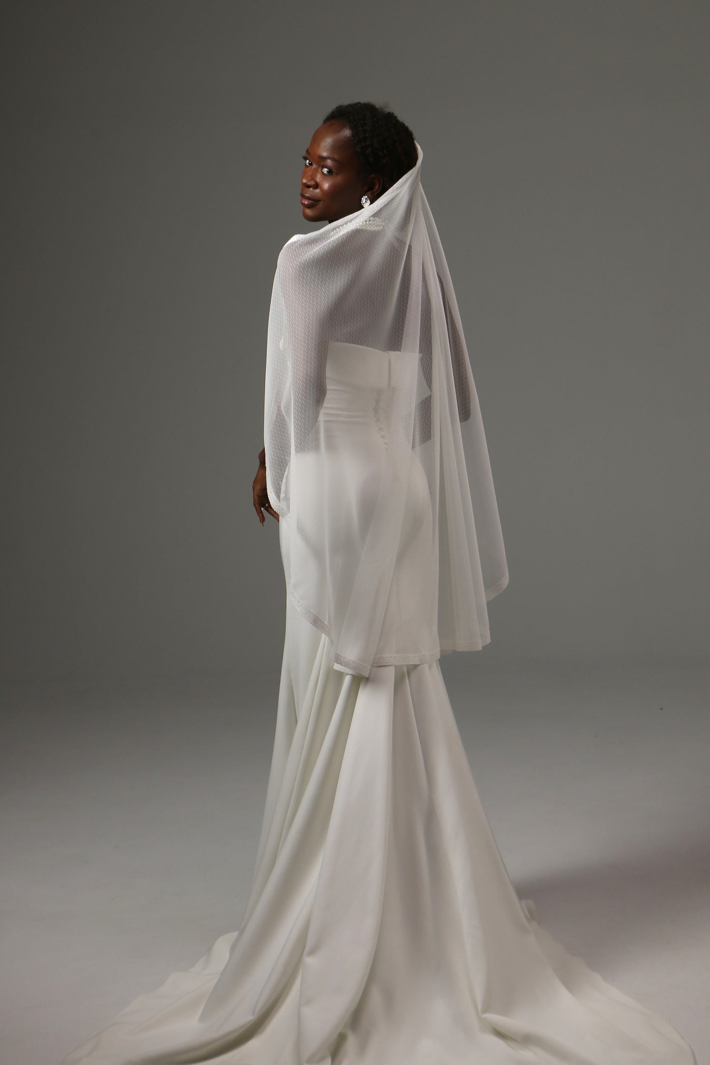 Handmade bridal veil with dotted tulle and feminine lace trim.