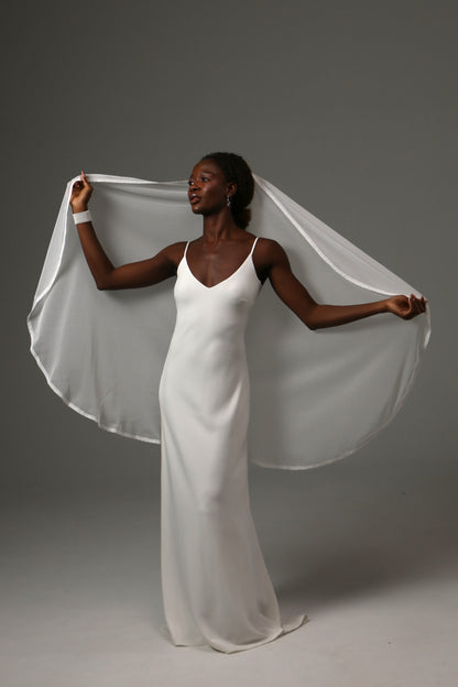 Romantic fingertip bridal veil featuring subtle dotted texture.
