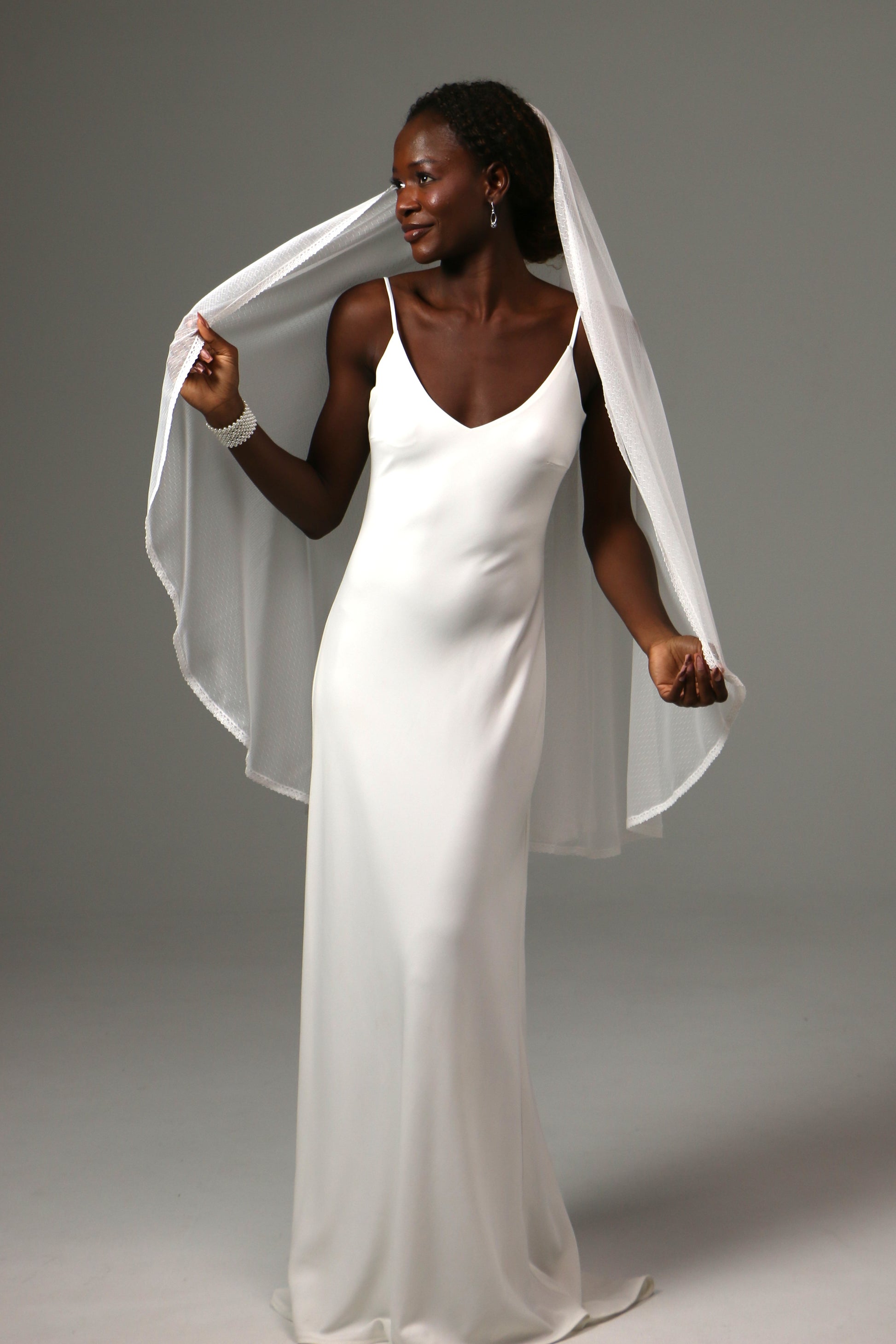 Handmade fingertip veil with refined lace border detail.
