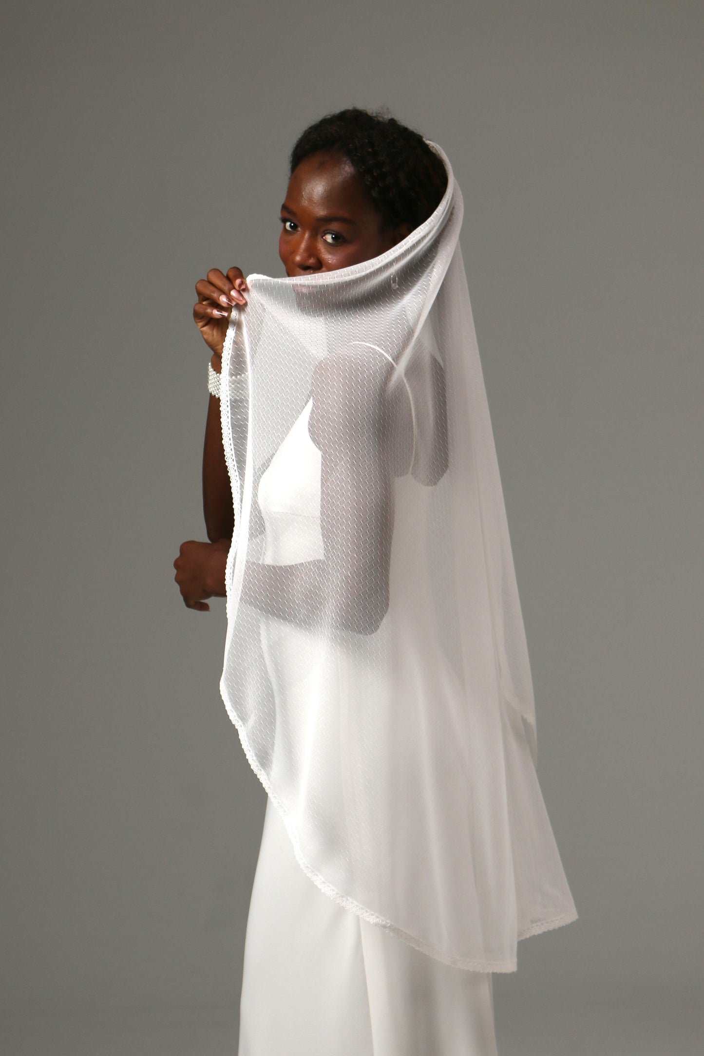 Soft tulle wedding veil creating a romantic bridal silhouette.