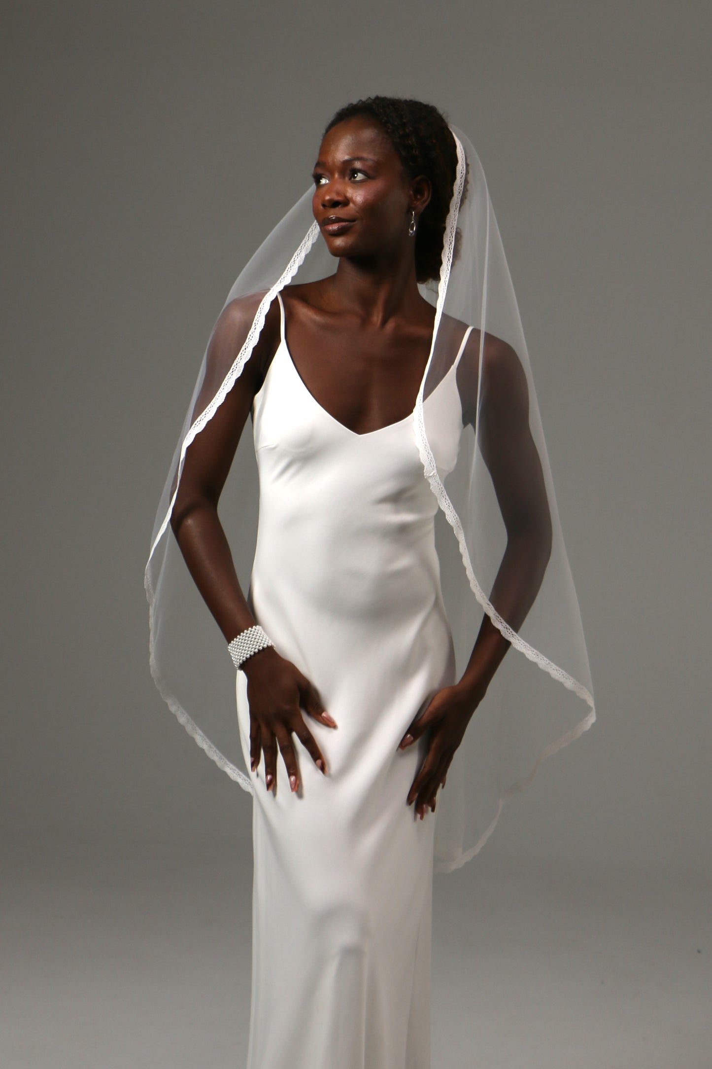 Classic bridal accessory with refined lace detailing.