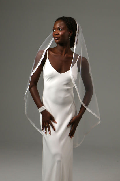 Classic bridal accessory with refined lace detailing.