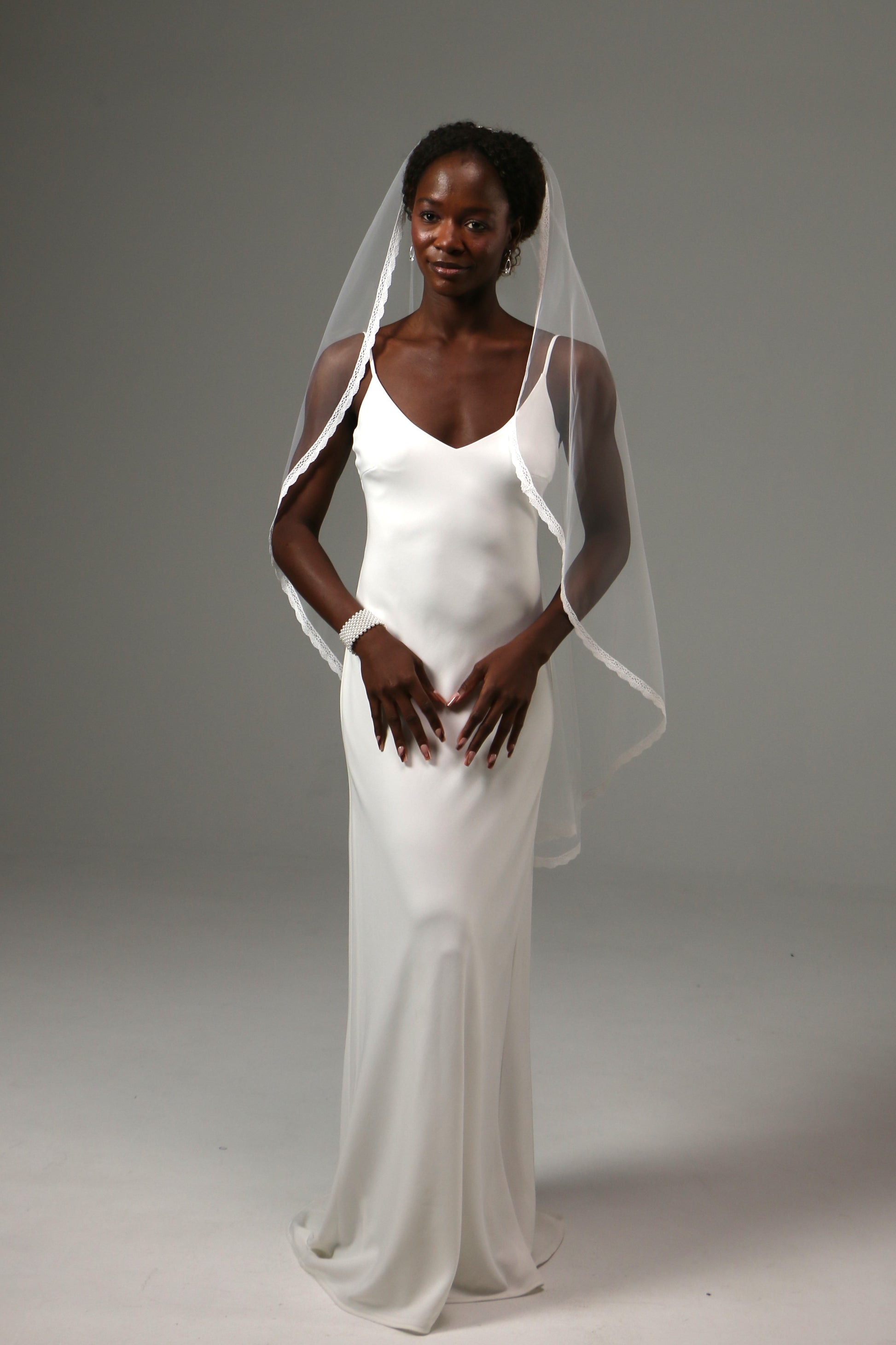 Soft tulle bridal veil creating a graceful silhouette.