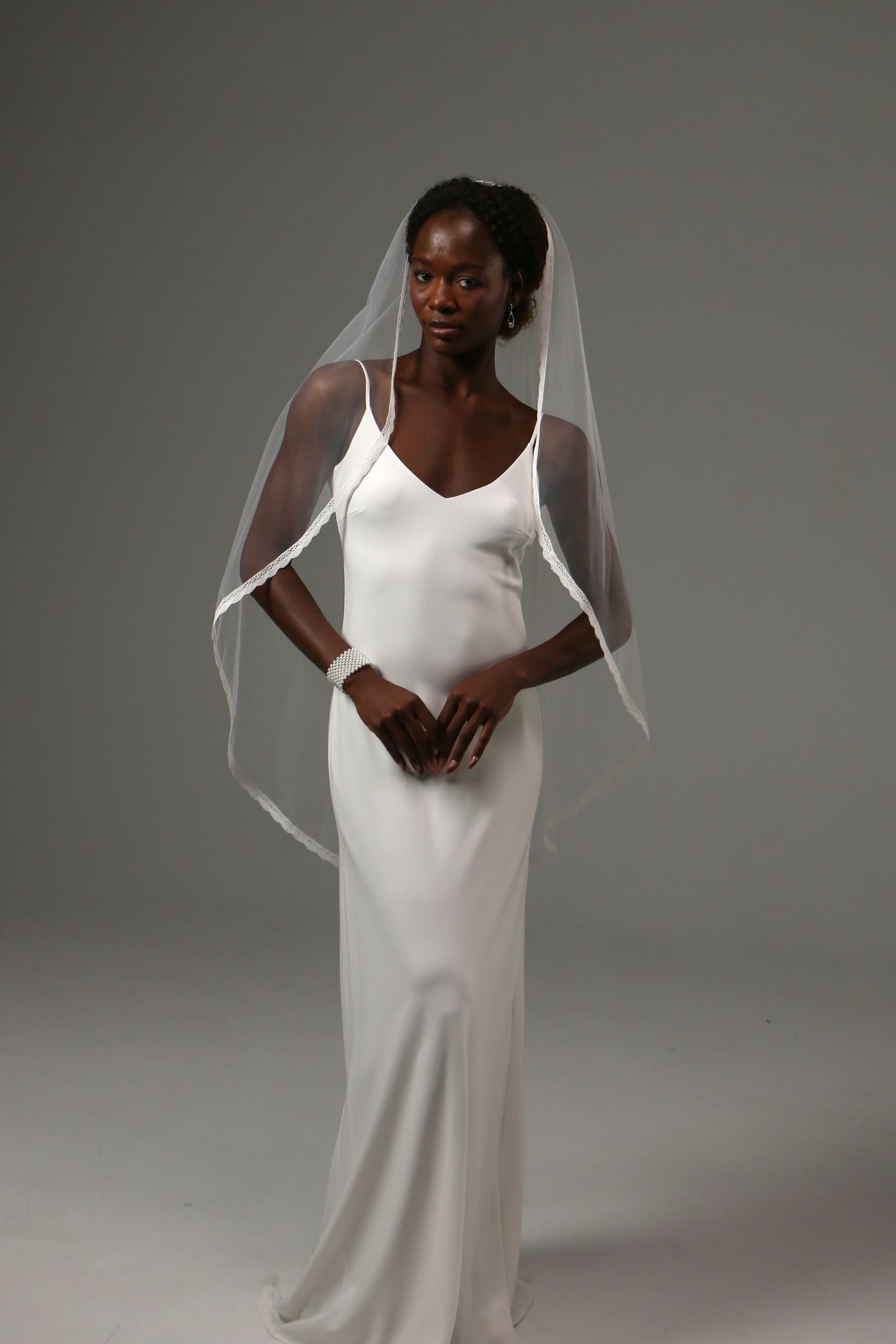 Handmade wedding veil with soft drape and lace edge finish.