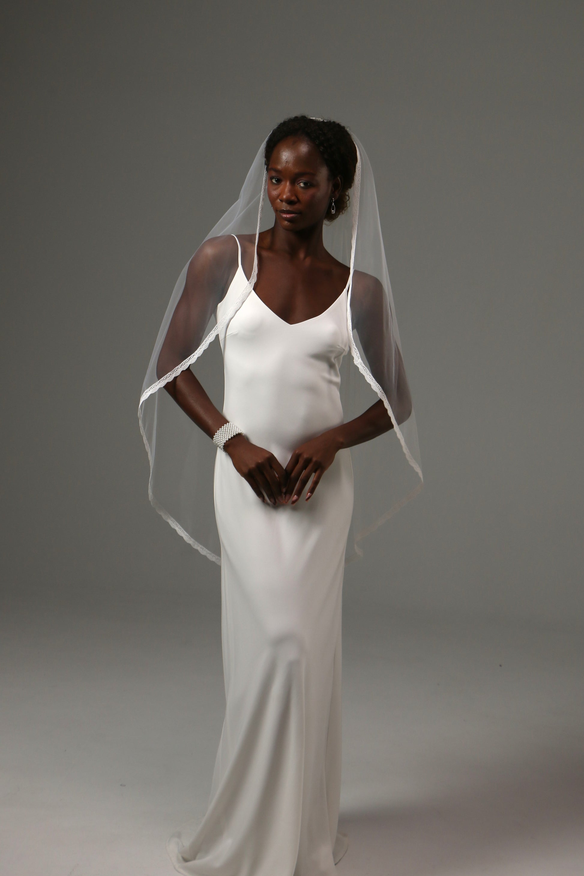 Handmade wedding veil with soft drape and lace edge finish.