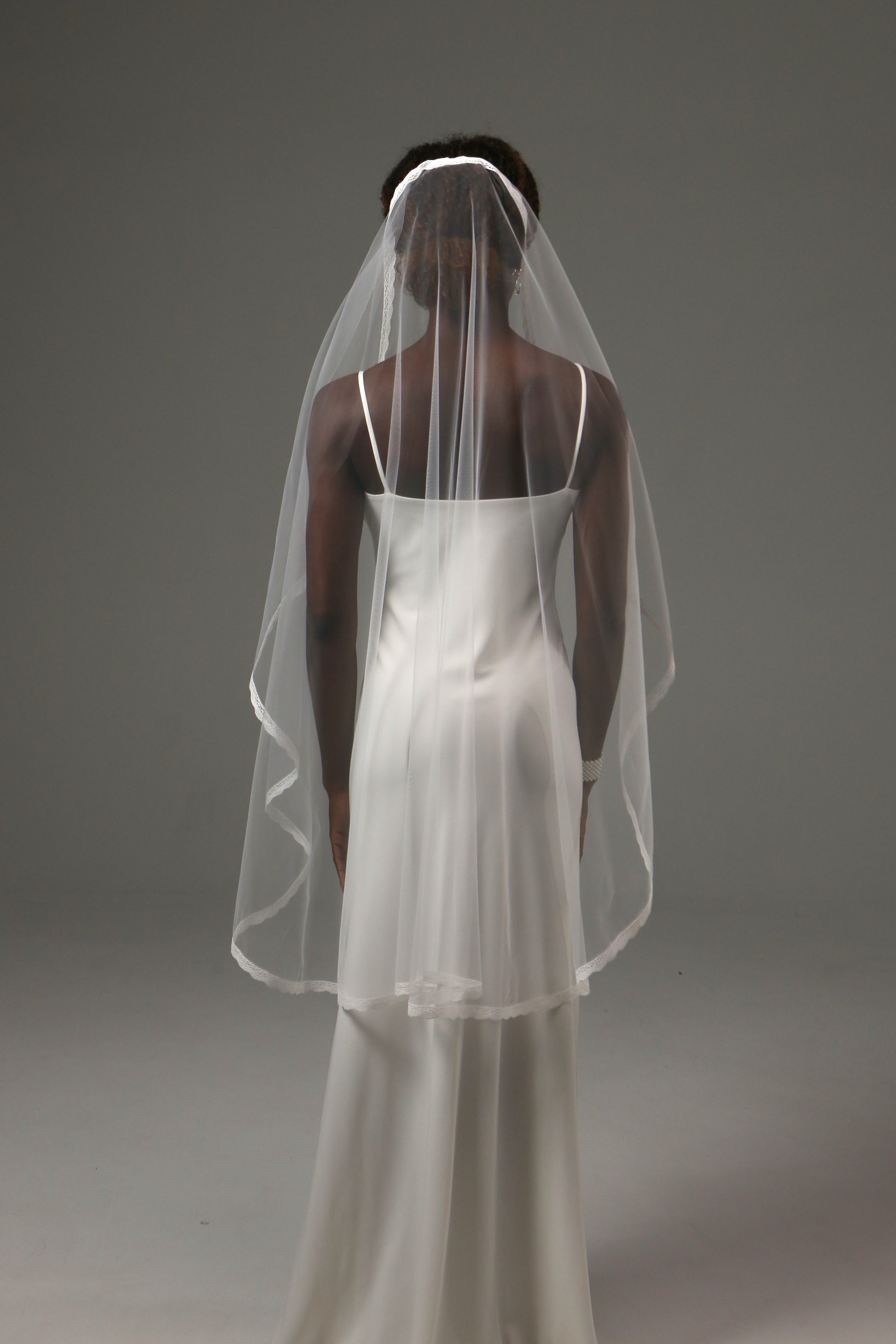 Modern wedding veil styled with a contemporary bridal gown.