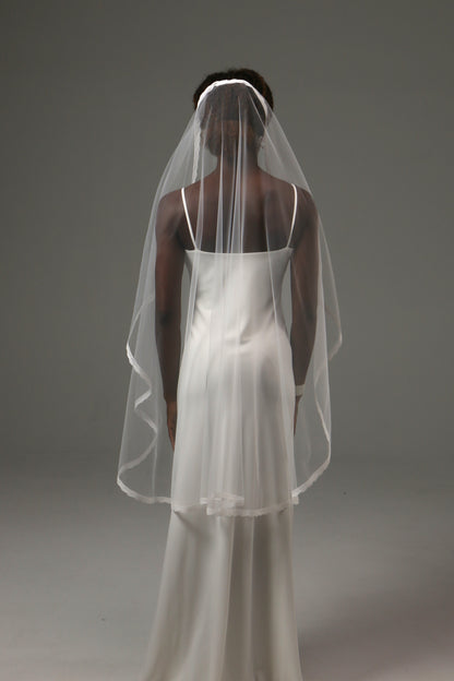 Modern wedding veil styled with a contemporary bridal gown.