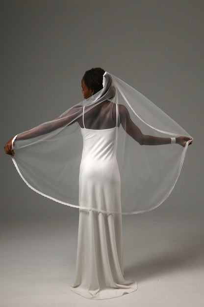 Elegant fingertip veil designed for romantic wedding ceremonies.