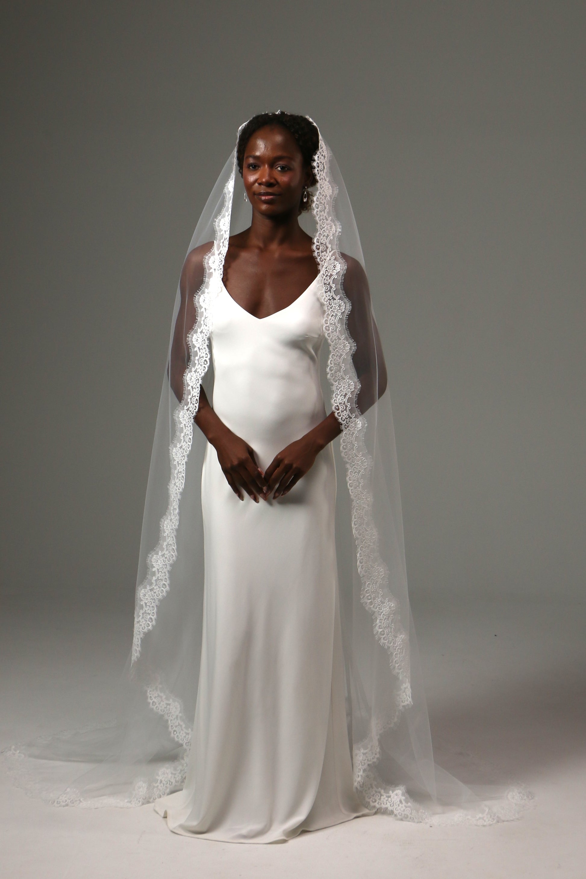 One-tier cathedral wedding veil with ornate lace edge trim.