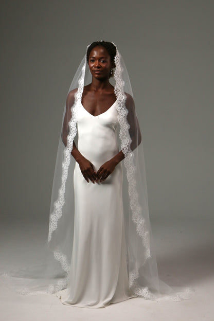 One-tier cathedral wedding veil with ornate lace edge trim.