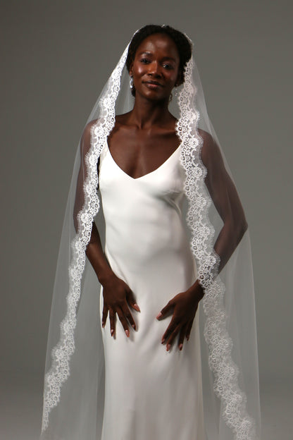 Romantic lace-edged veil designed for classic wedding styling.