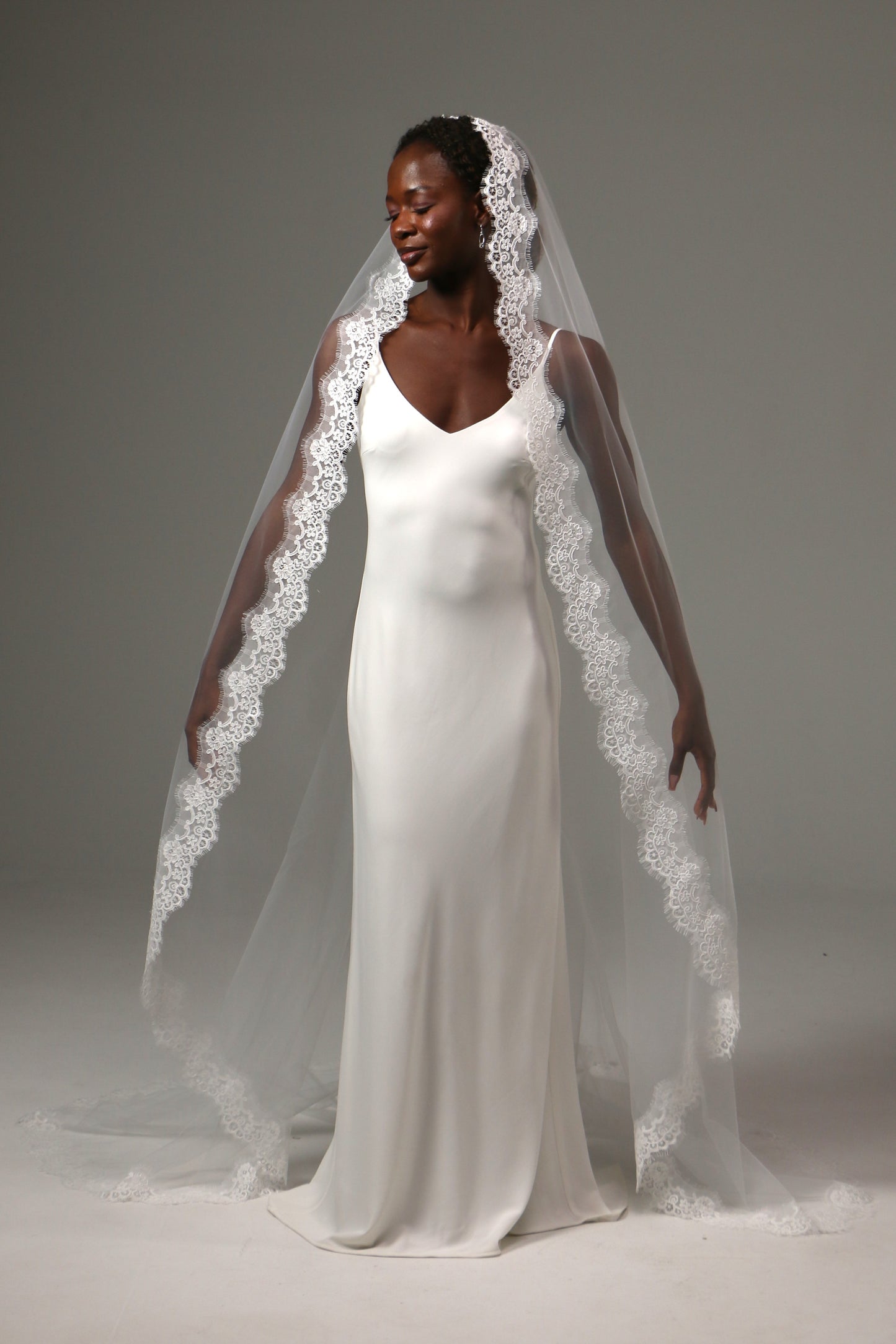 Elegant bridal accessory with flowing cathedral-length train.