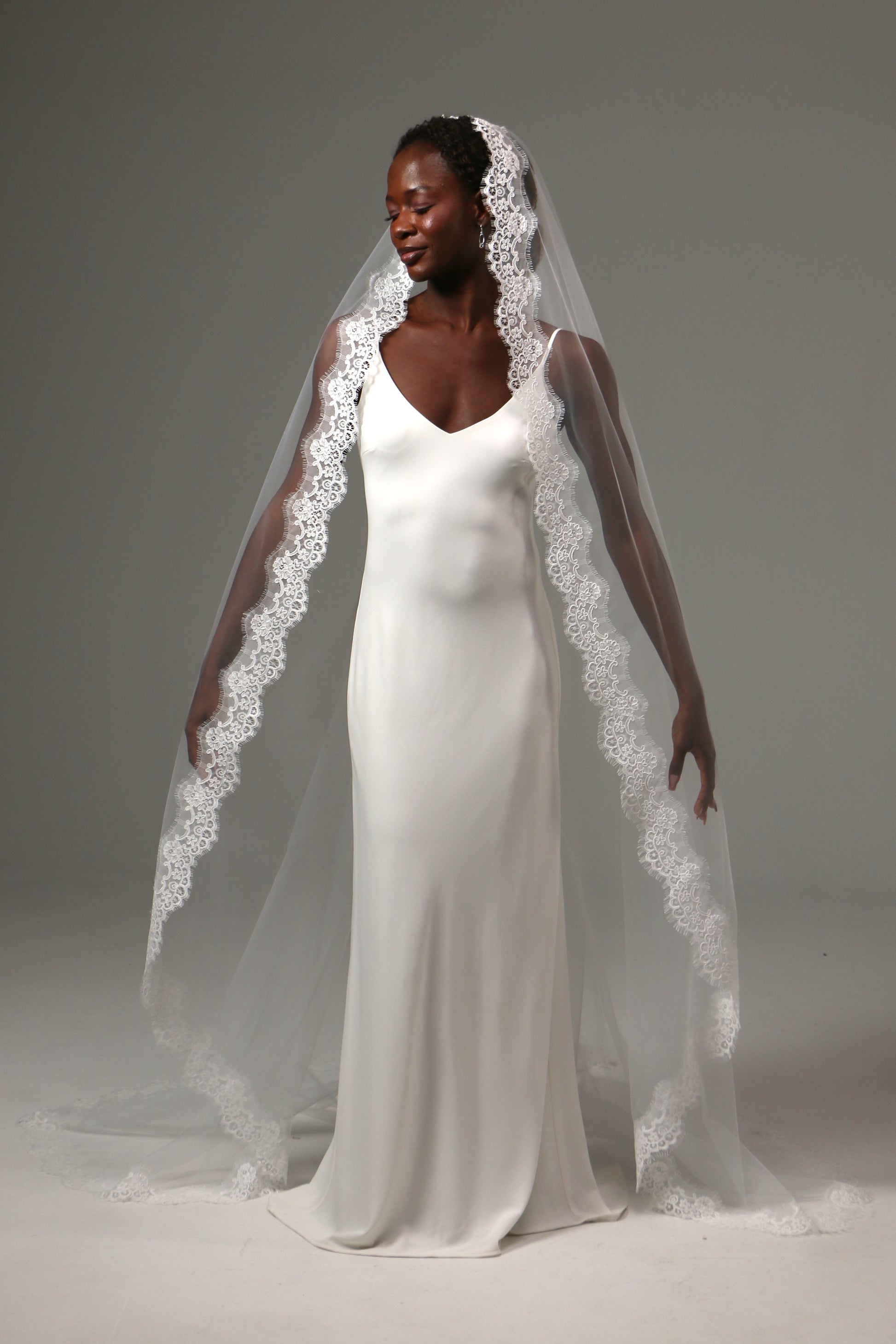 Elegant bridal accessory with flowing cathedral-length train.