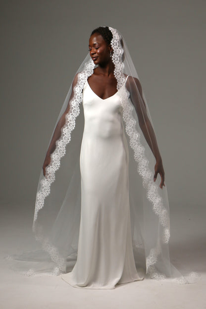 Elegant bridal accessory with flowing cathedral-length train.
