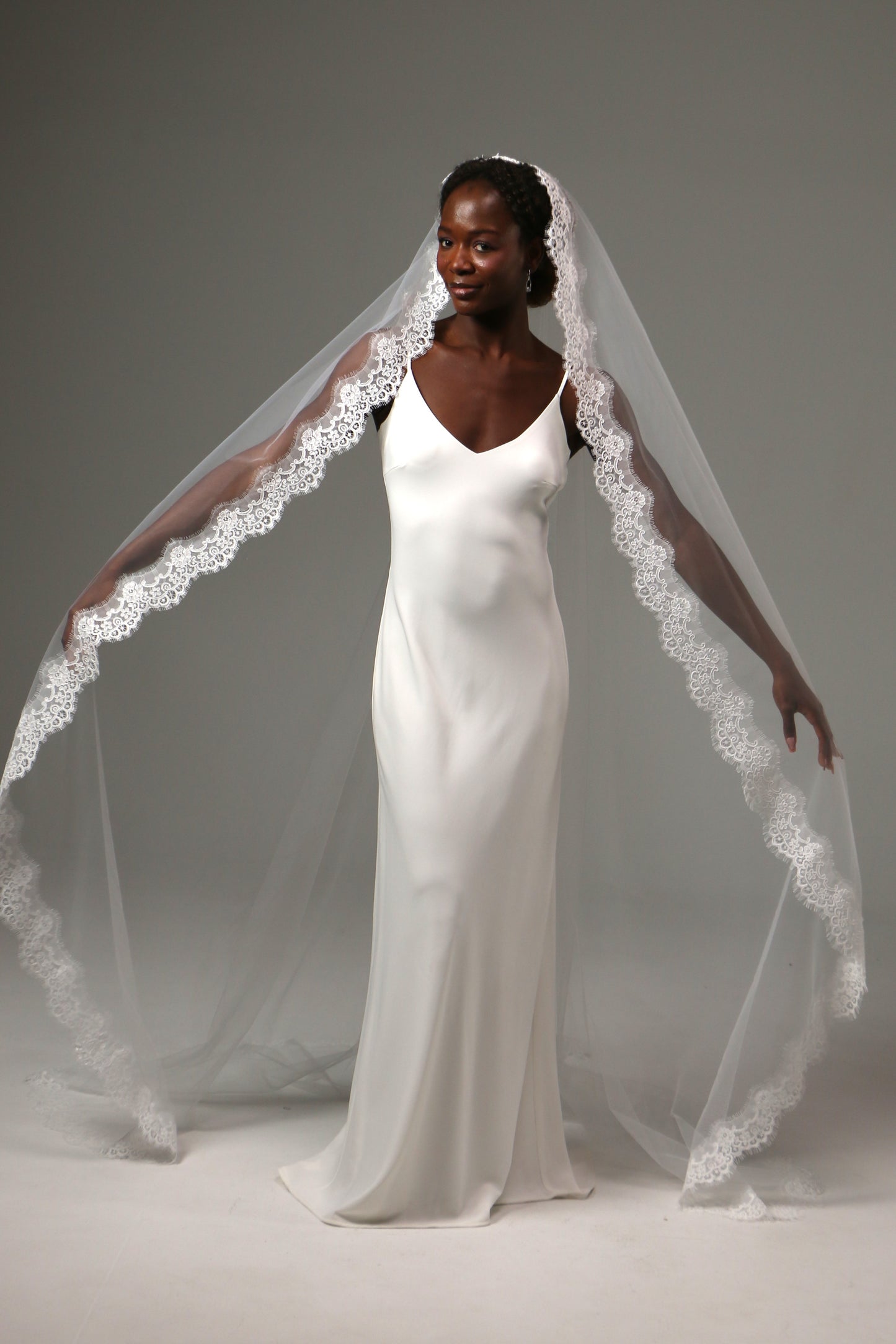 Soft tulle cathedral veil with graceful flowing movement.
