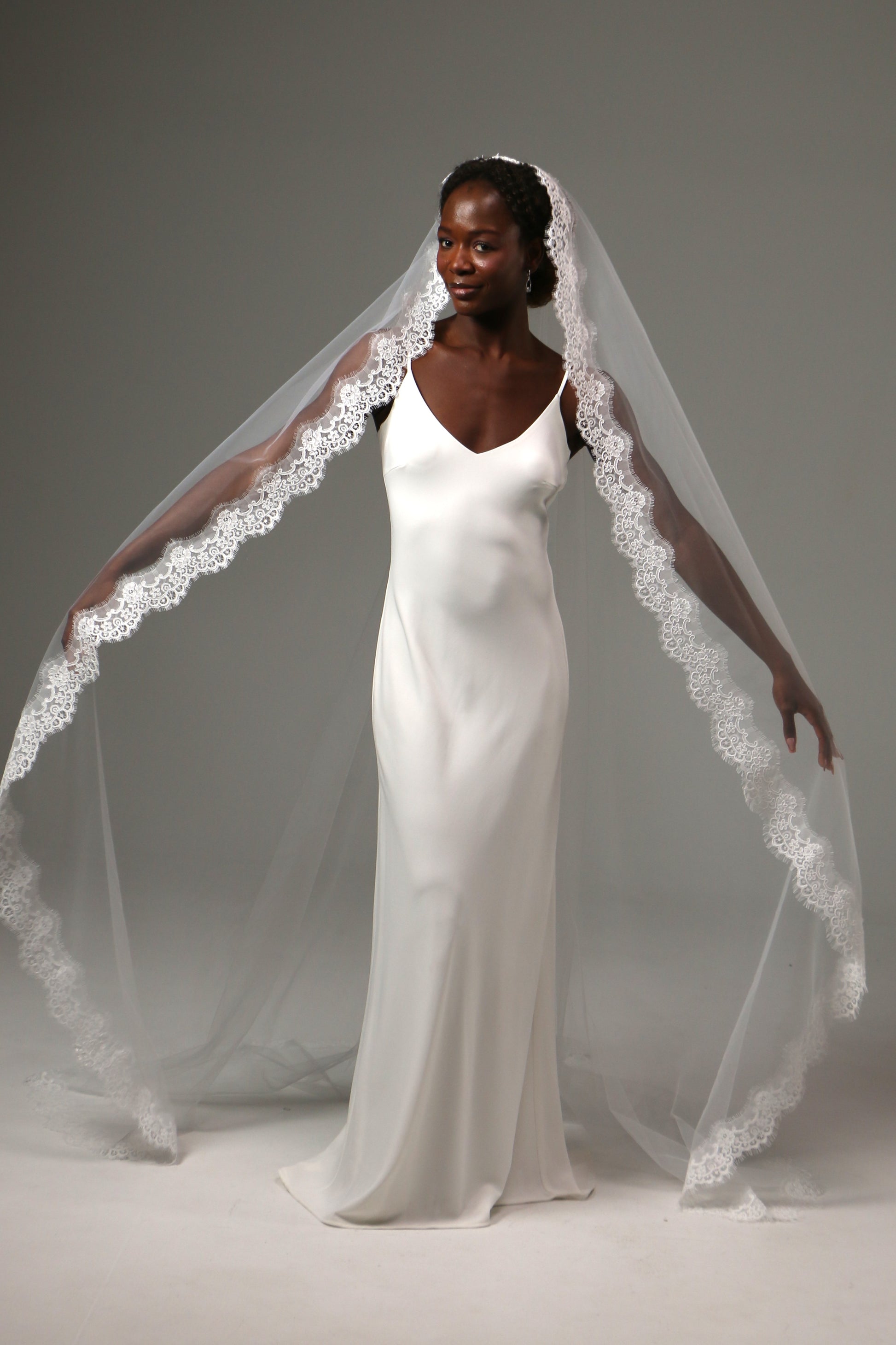Soft tulle cathedral veil with graceful flowing movement.
