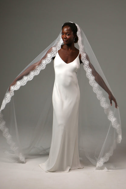 Soft tulle cathedral veil with graceful flowing movement.