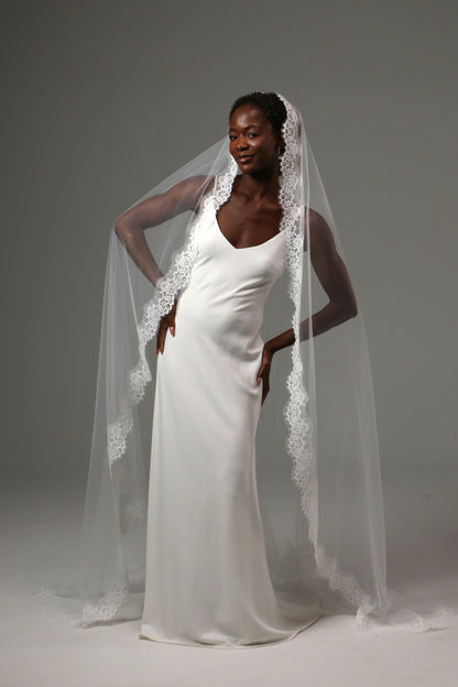 Romantic wedding veil paired with a minimalist satin gown.