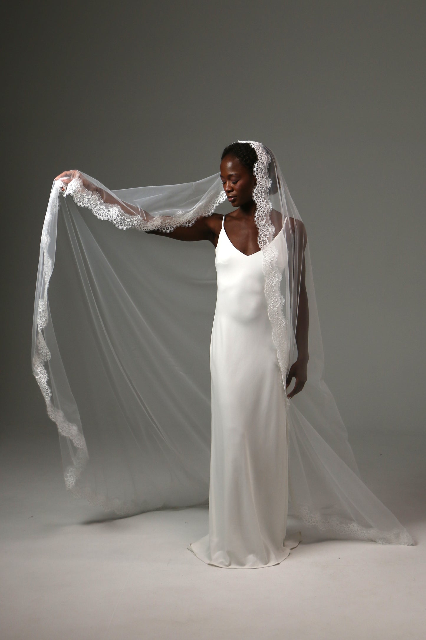 Handmade bridal veil featuring detailed lace trim throughout.