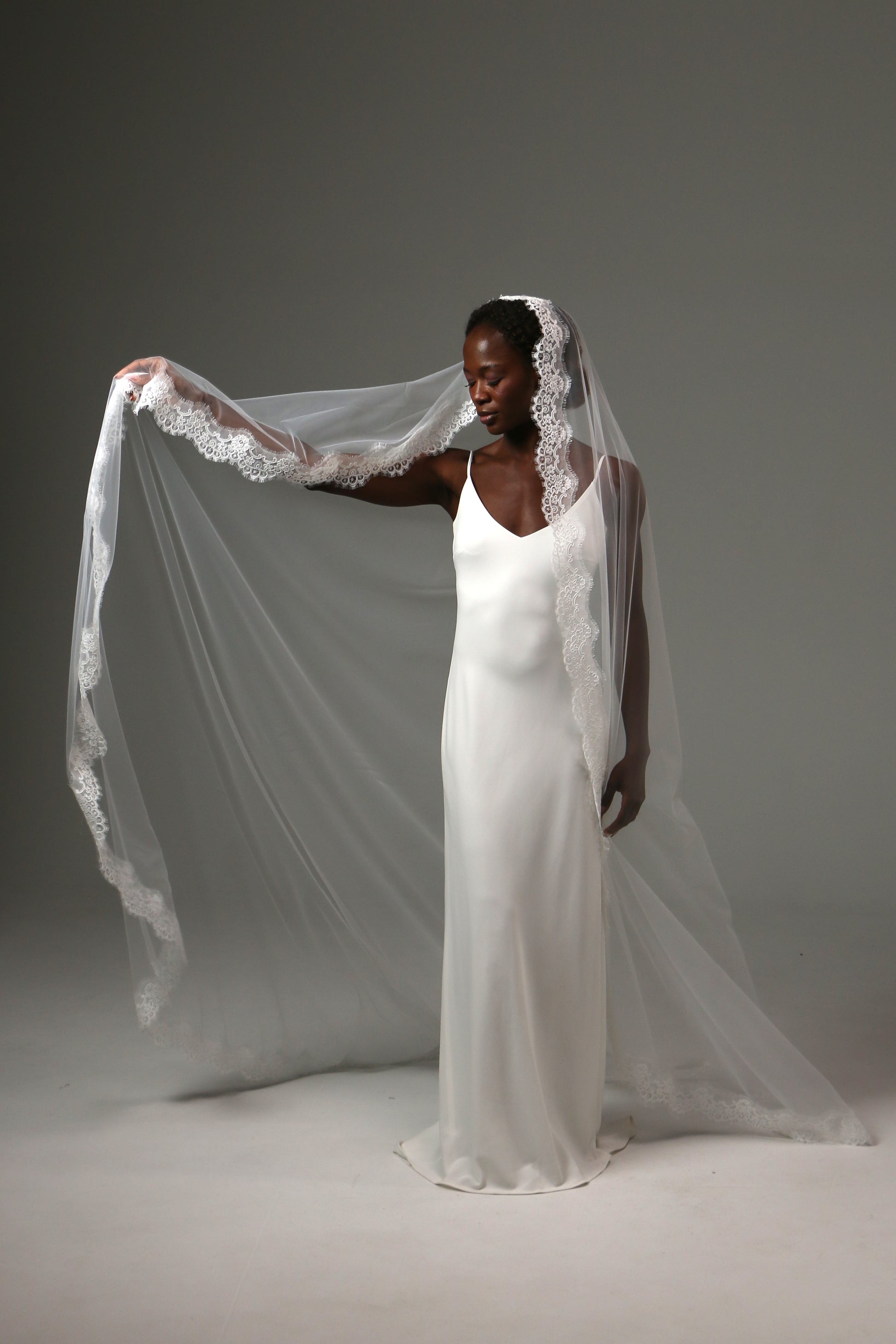 Handmade bridal veil featuring detailed lace trim throughout.