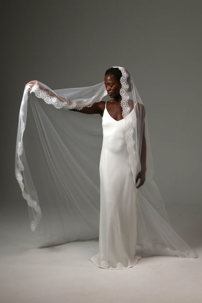 Handmade bridal veil featuring detailed lace trim throughout.