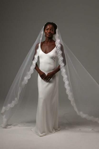 Luxury wedding veil with soft illusion tulle and lace detailing.