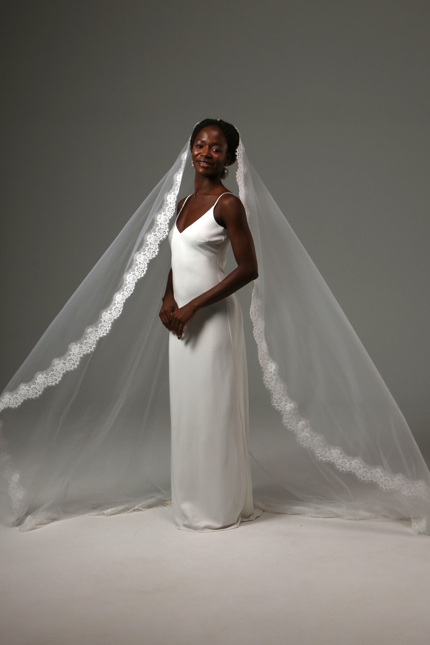 Elegant cathedral wedding veil creating a timeless silhouette.